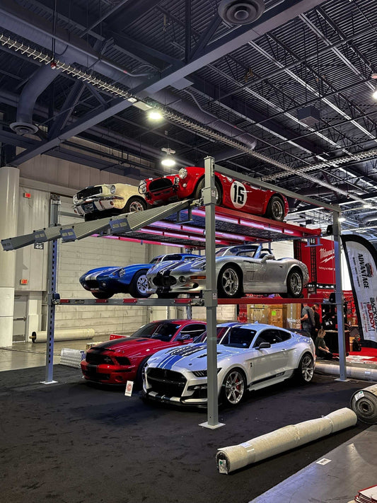 Advantage Double-Wide Triple Stacker 6-car tri-level 4-post lift showcasing classic and sports cars in a garage setting