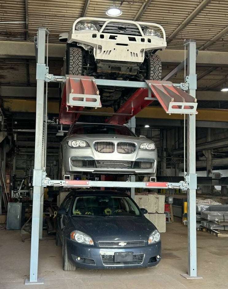Advantage Single-Wide Triple Stacker car lift with three vehicles stacked vertically in a garage.