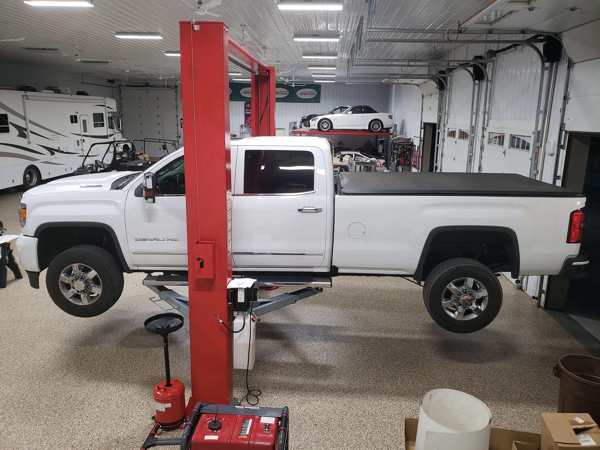 Advantage AL-12C 2-post lift with truck elevated in garage.
