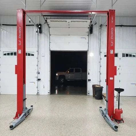 Advantage AL-12C 2-post lift with truck elevated in garage.