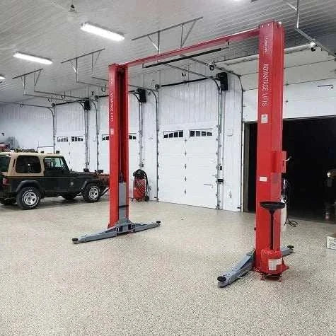 Advantage AL-12C 2-post lift with truck elevated in garage.