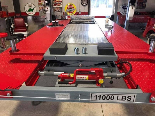 Advantage Lifts Rolling Jack manual hand pump with 11000 lbs capacity on red four-post lift platform
