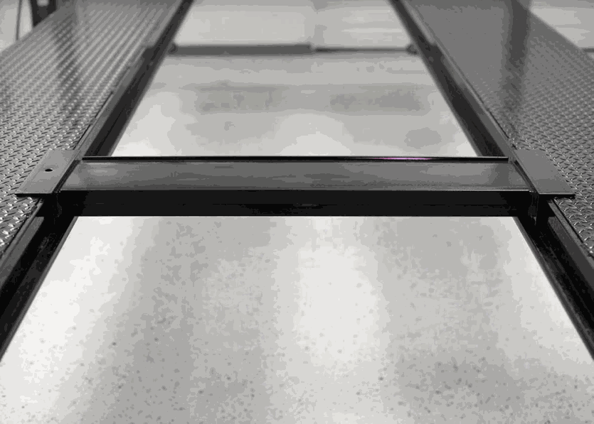 Sliding Jack Platform made of black metal with sliding mechanism for bottle or small jacks, 8 inches wide, 7000 lb capacity, used on vehicle lifts.