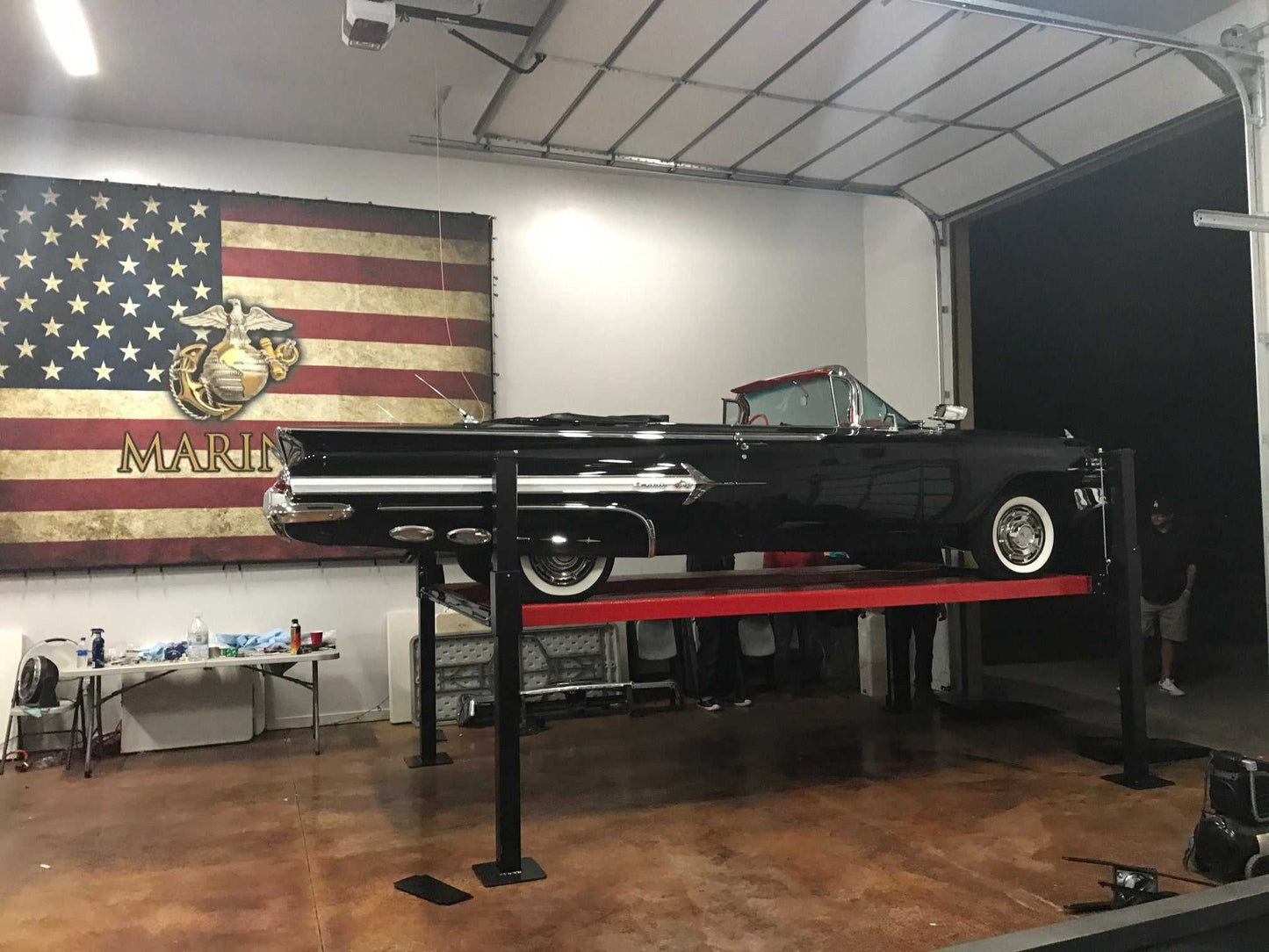 7,000 lbs Backyard Buddy Classic 4-post lift with two red cars in garage.