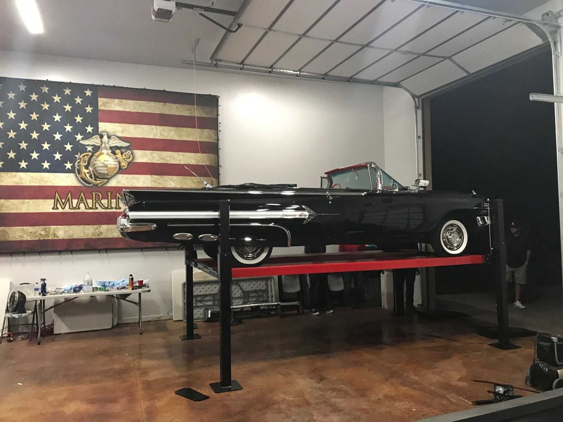 7,000 lbs Backyard Buddy Classic 4-post lift with two red cars in garage.
