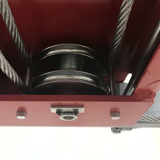 Industrial grade steel cables and pulleys on 4-post lift for durability and stability