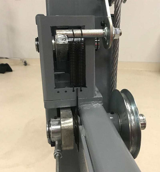 Close-up of 4-post automotive lift showing primary and secondary locking systems for enhanced safety