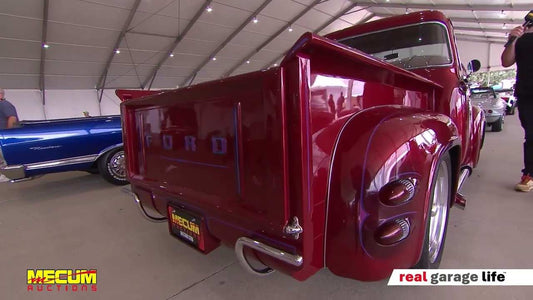 Red vintage Ford pickup truck displayed at Mecum Auctions Florida Summer Special 2025 event