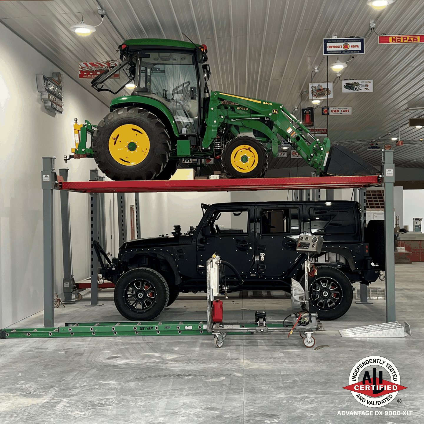 Advantage DX-9000-XLT 4-post lift demonstrating a tractor and Jeep vehicle vertically stacked.