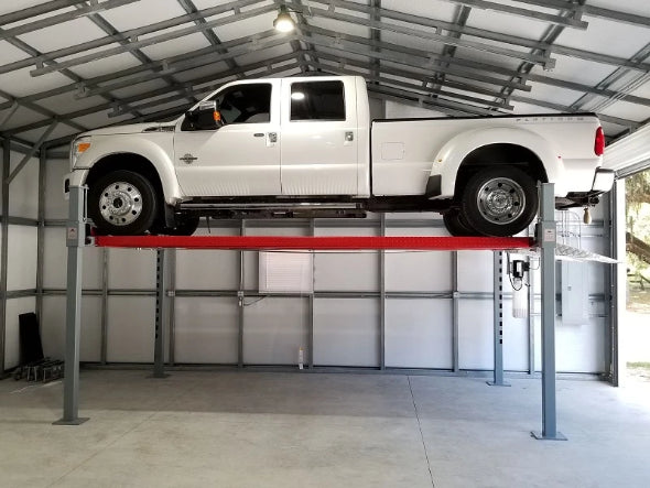 11,000 Pound Heavy Duty Advantage Auto Lift lifting a truck at max height