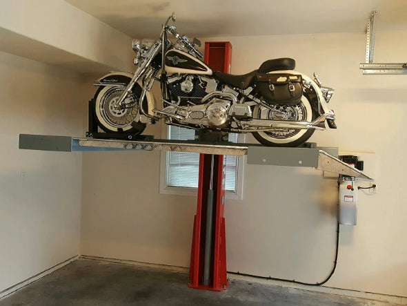 Advantages single-post vehicle lift creating space by lifting a motorcycle in a home garage